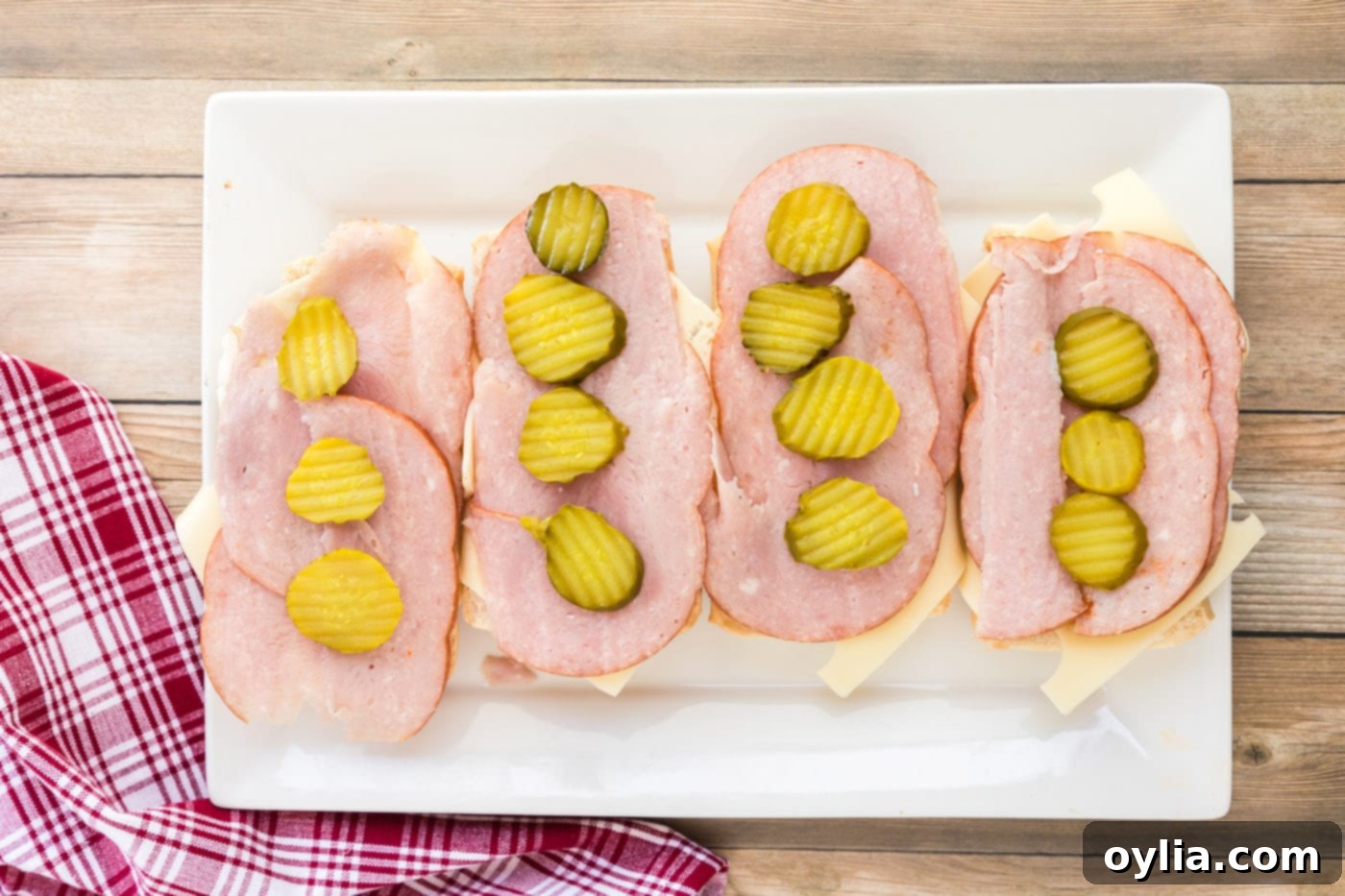 Pickle rounds placed strategically on top of ham and Swiss cheese for the Cubano