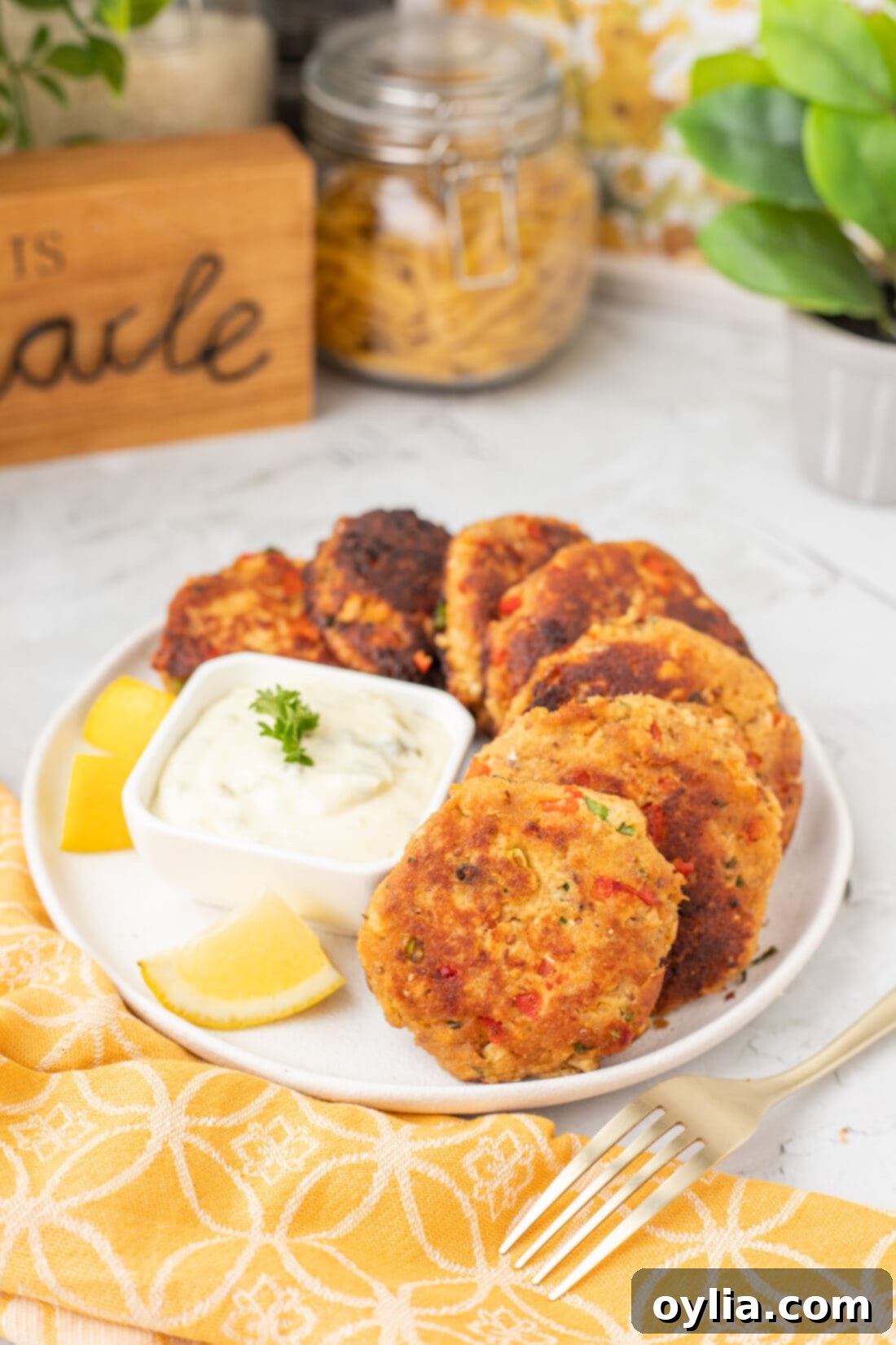 Crispy Golden Salmon Croquettes 9 Plated Salmon Croquettes with a generous dollop of white sauce