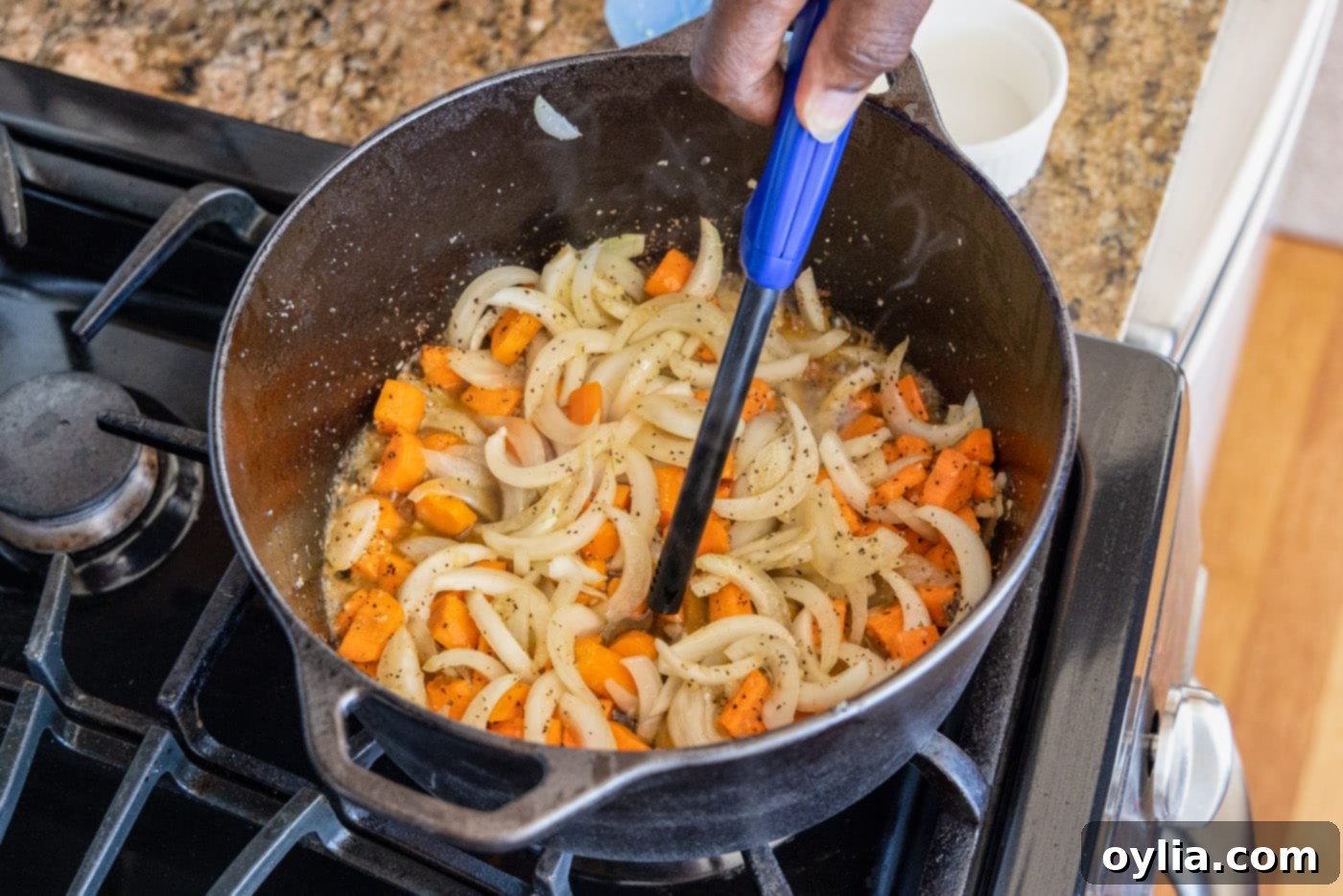 Lighting Cognac over the sautéed onions and carrots in a Dutch oven, creating flames