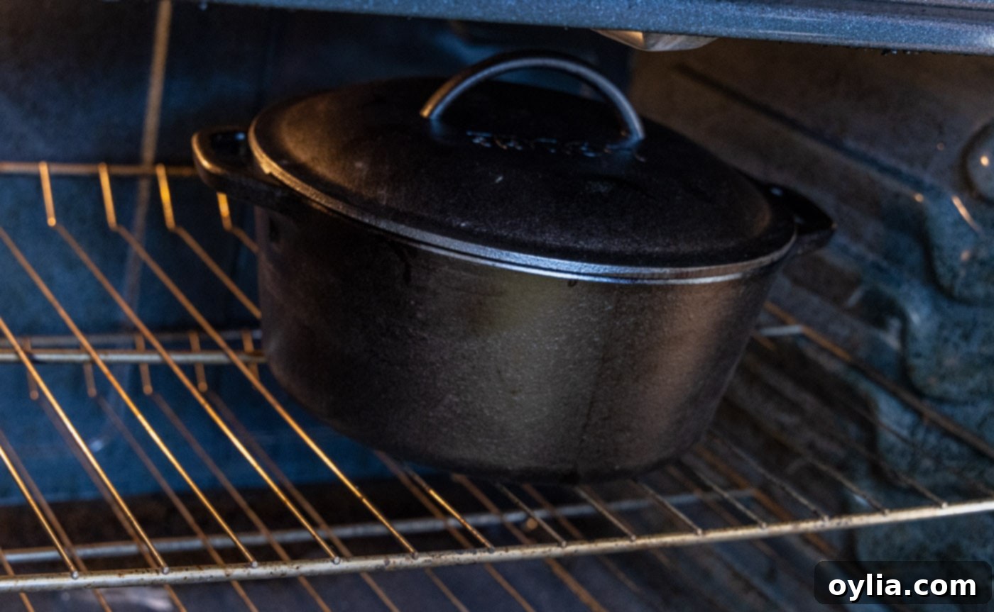 A Dutch oven containing Beef Bourguignon baking in the preheated oven