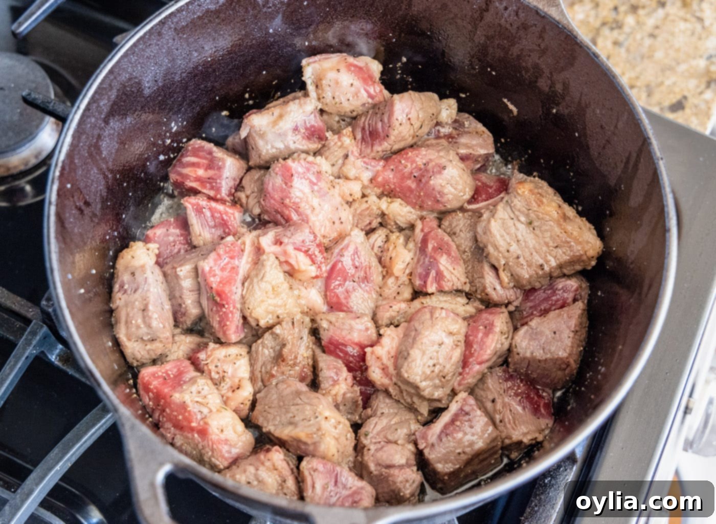Perfectly browned beef chuck cubes in a Dutch oven, ready for the next step