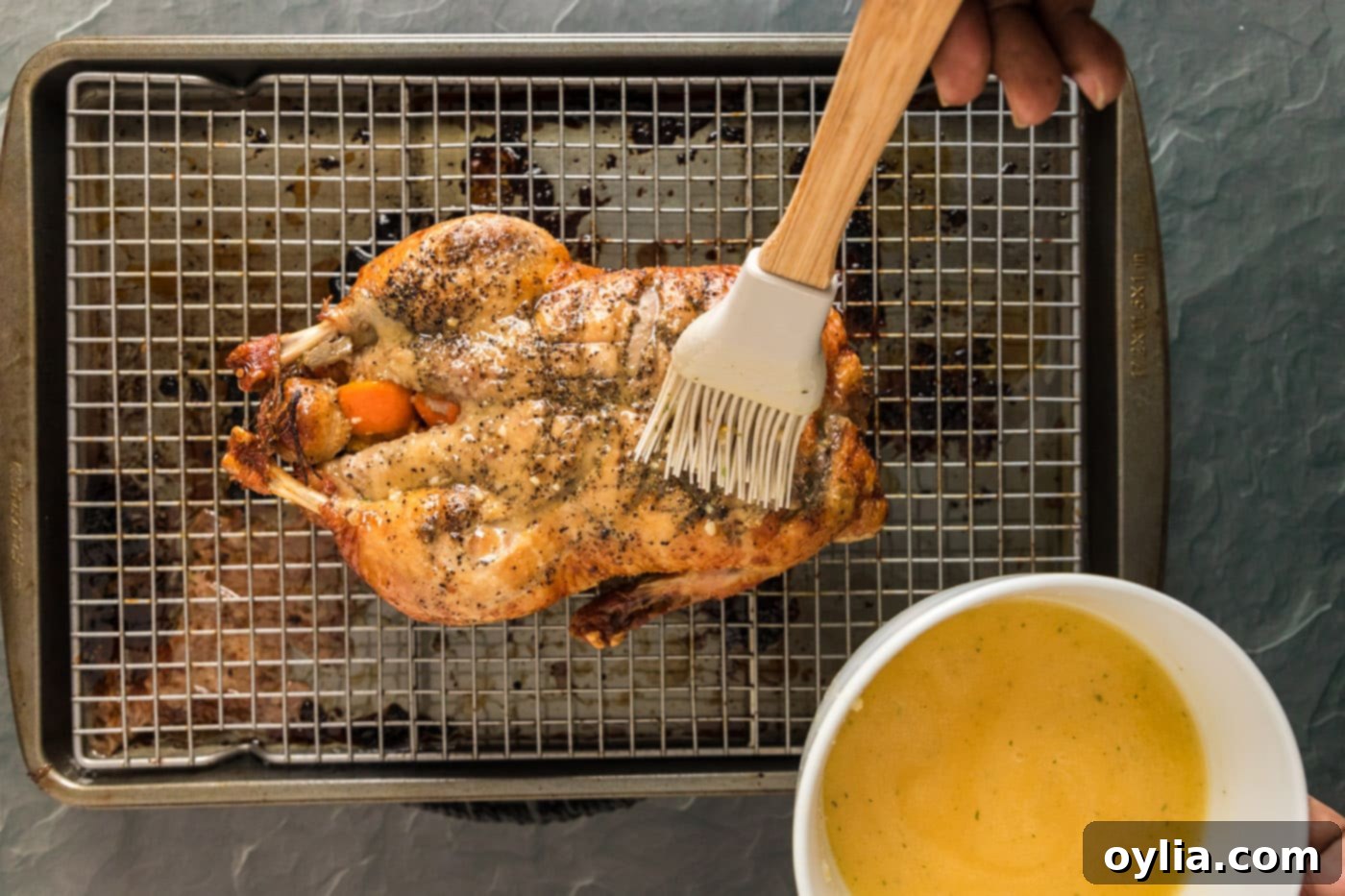 bating whole duck with mandarin juice and butter