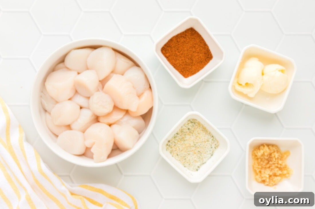 Crispy Air-Fried Scallops 4 Ingredients laid out for Air Fryer Scallops: scallops, Old Bay, garlic salt, butter, and minced garlic