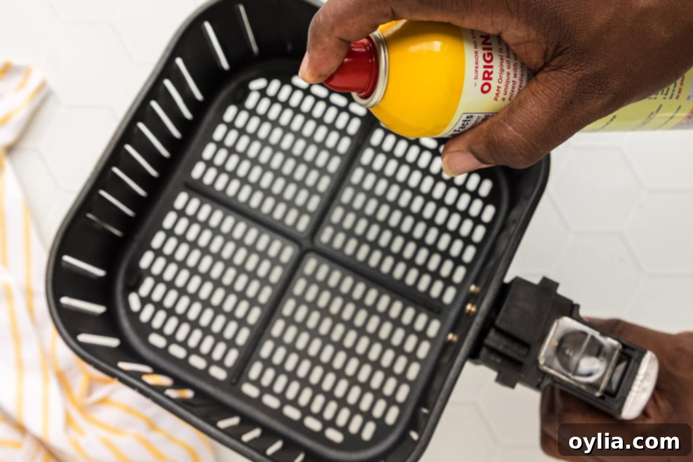 Crispy Air-Fried Scallops 6 Spraying an air fryer basket with cooking spray