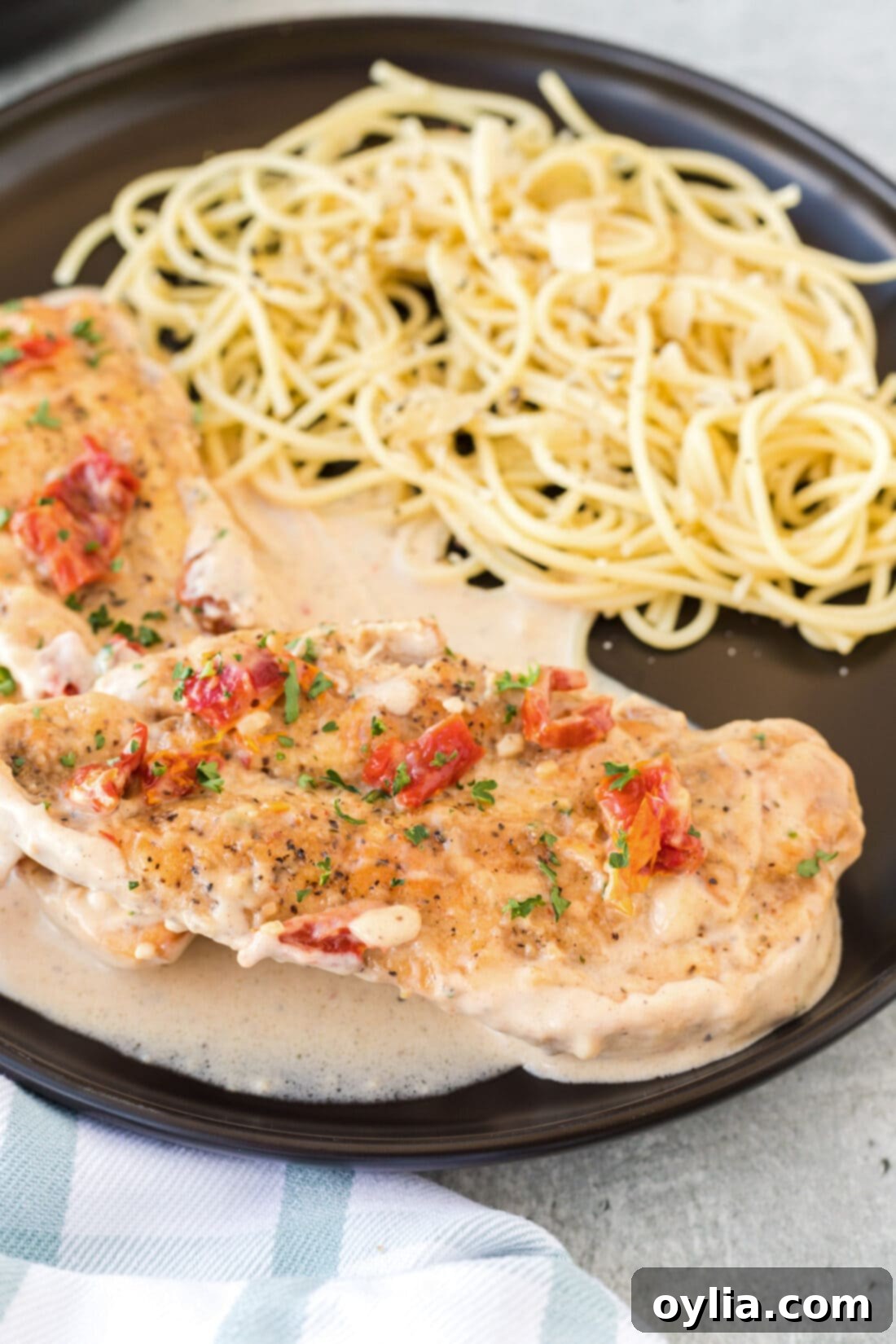 Marry Me Chicken served with spaghetti, highlighting the creamy sauce and sun-dried tomatoes