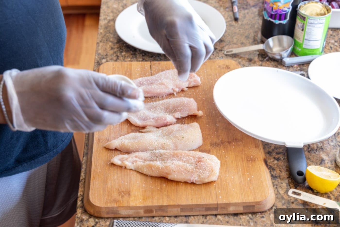 Seasoning chicken cutlets with garlic salt and black pepper