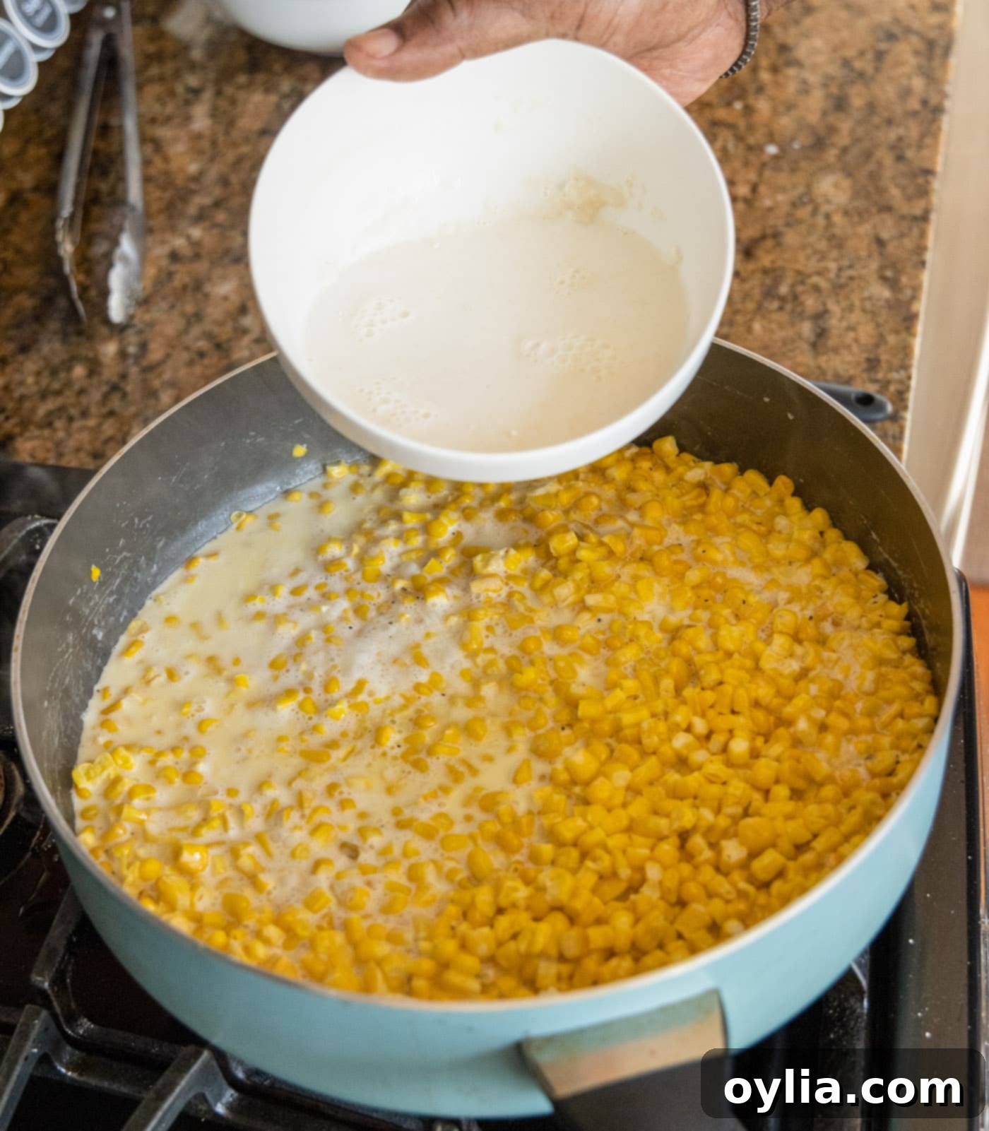 adding milk and flour mixture to creamed corn