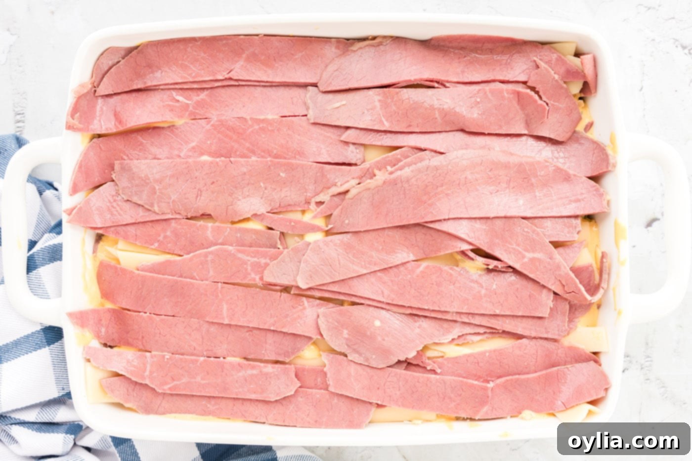 layer of corned beef strips in a baking dish