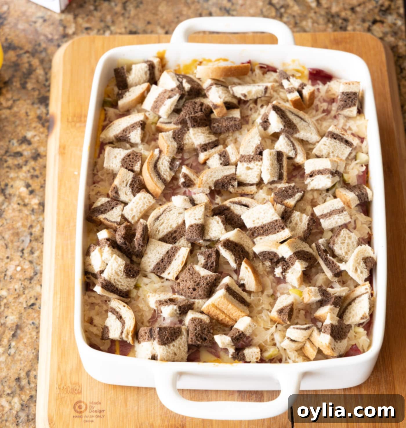 adding bread cubes to the top of reuben casserole