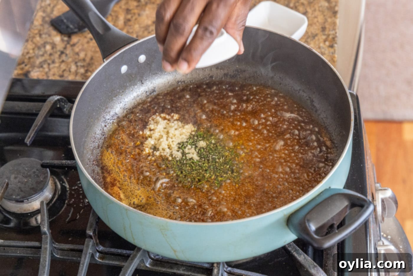 adding garlic, rosemary, and lemon juice to skillet