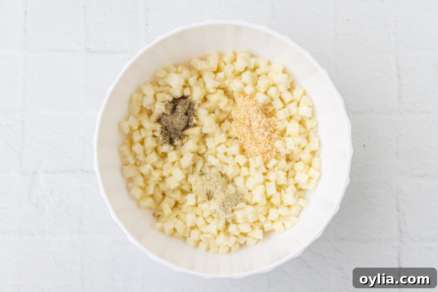 diced potatoes with seasonings in a bowl