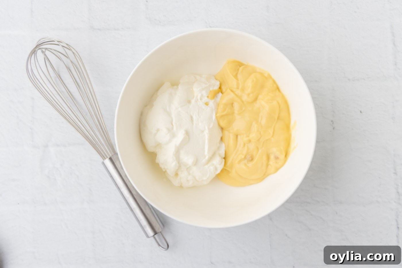 cream of chicken soup and sour cream in a bowl