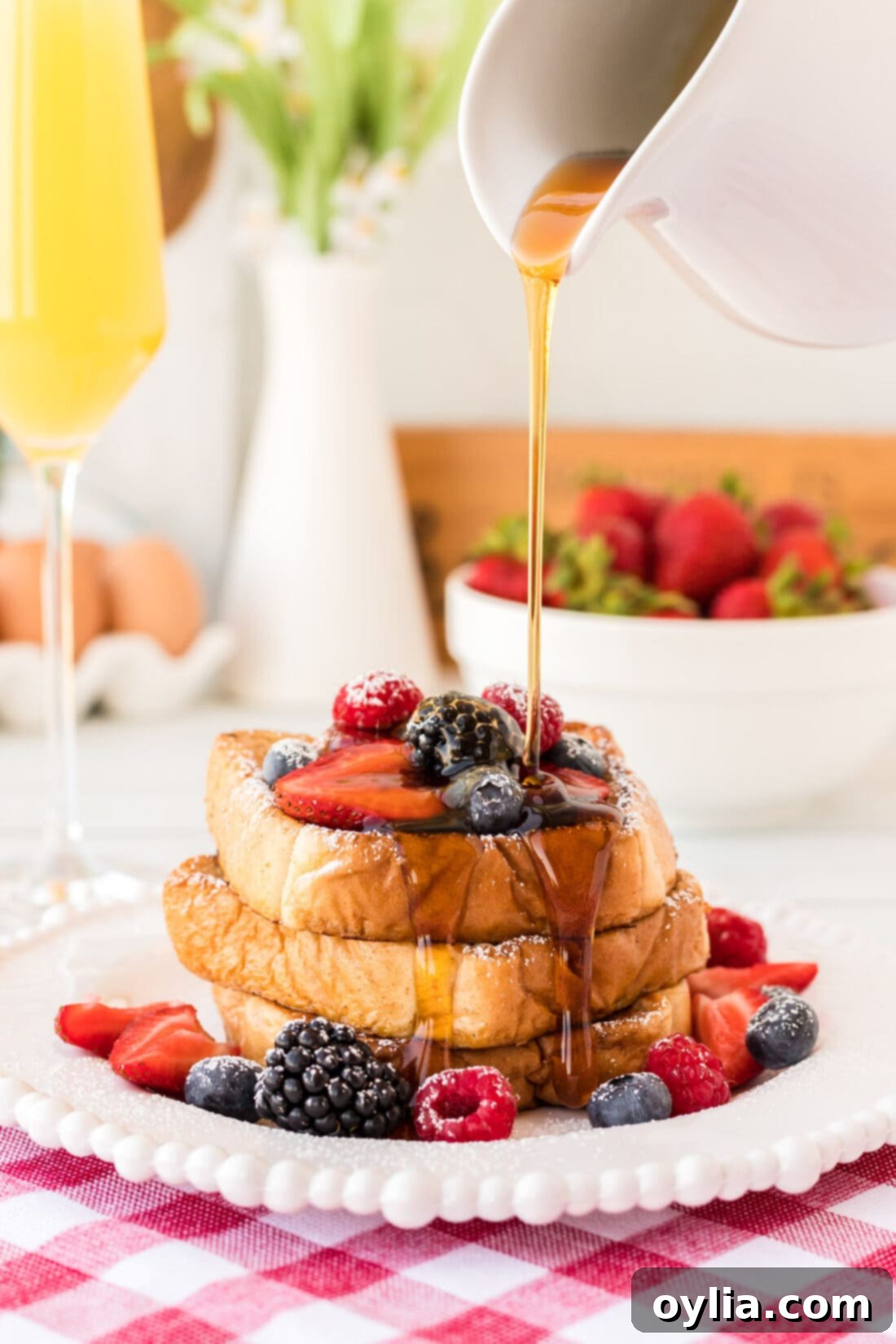 Drizzling maple syrup generously over freshly made thick and fluffy French Toast