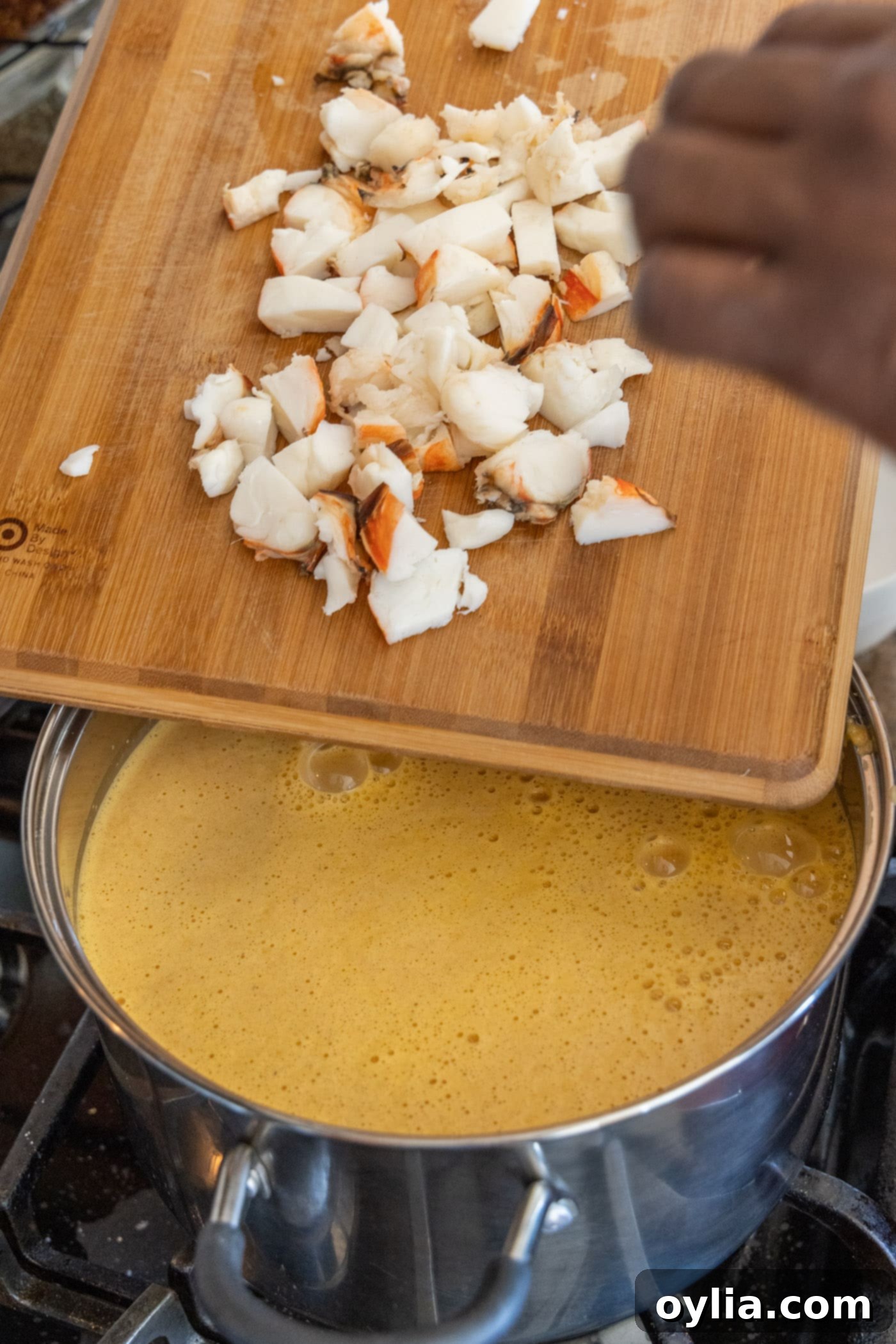 Velvet Sea Treasure 11 chopped cooked lobster pieces added to a rich, creamy pot of bisque