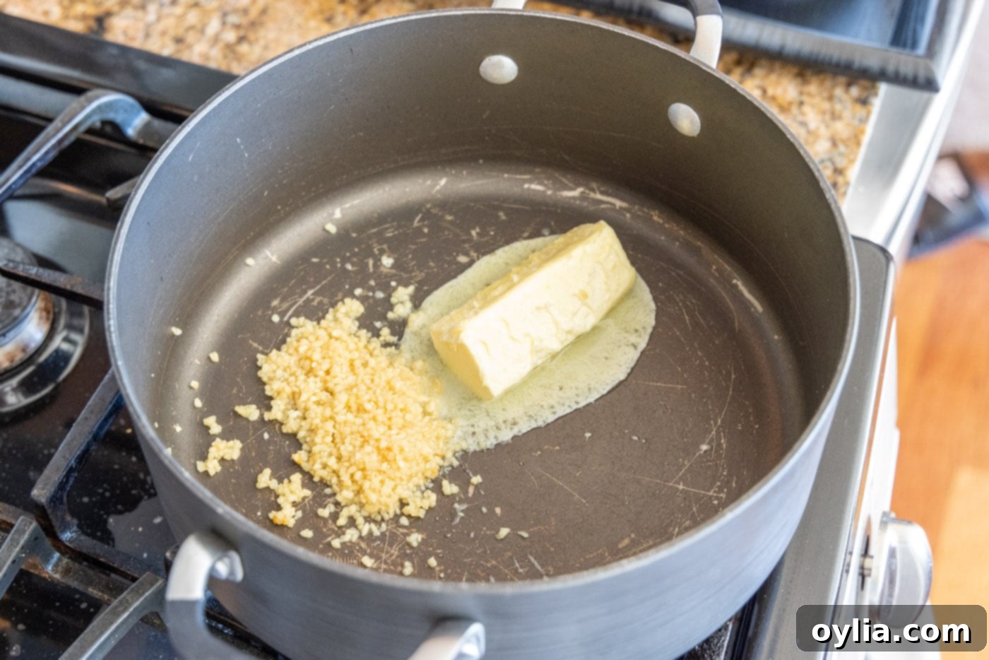 Velvet Sea Treasure 5 minced garlic with butter gently sizzling in a Dutch oven