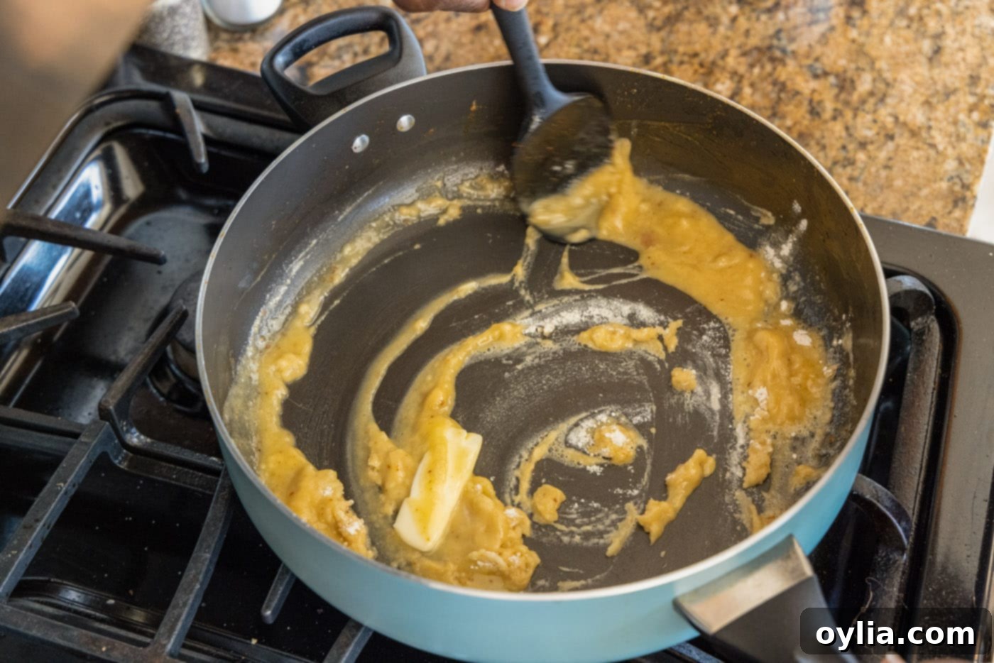 spatula stirring roux in skillet