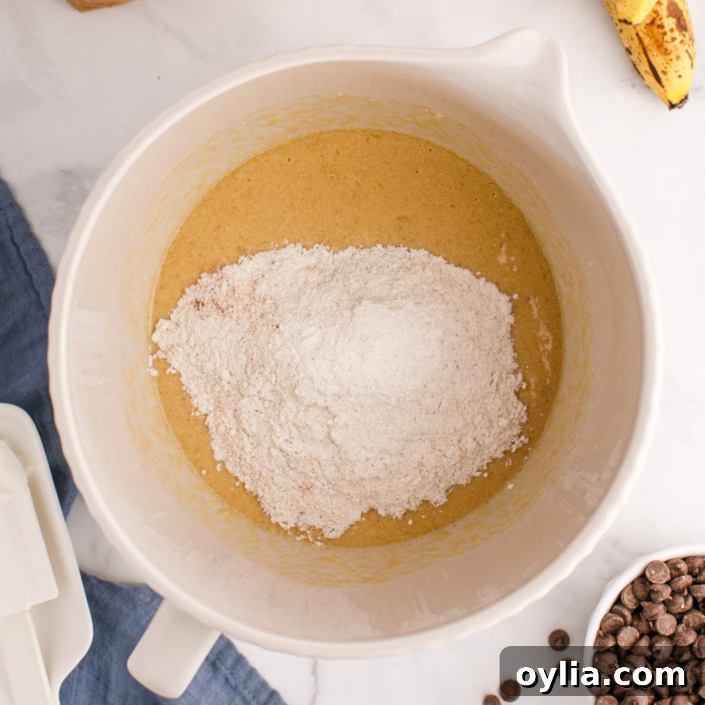 adding flour to muffin batter