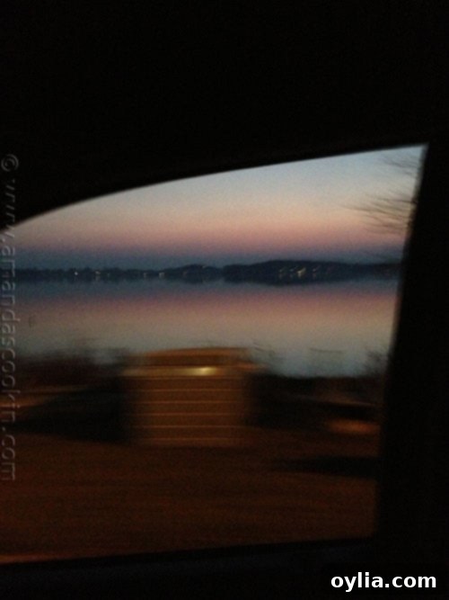 Sunset over a tranquil lake, captured from a moving car