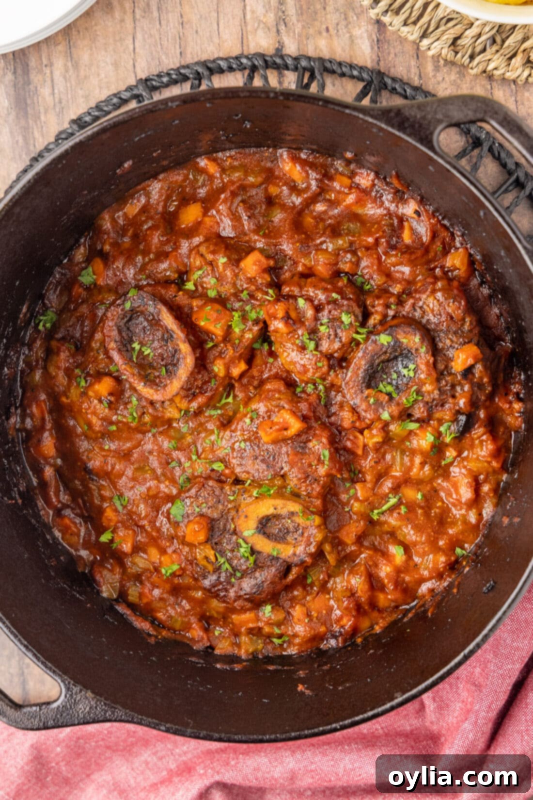 Veal Osso Bucco in a dutch oven, showcasing the rich, slow-cooked meat with vegetables