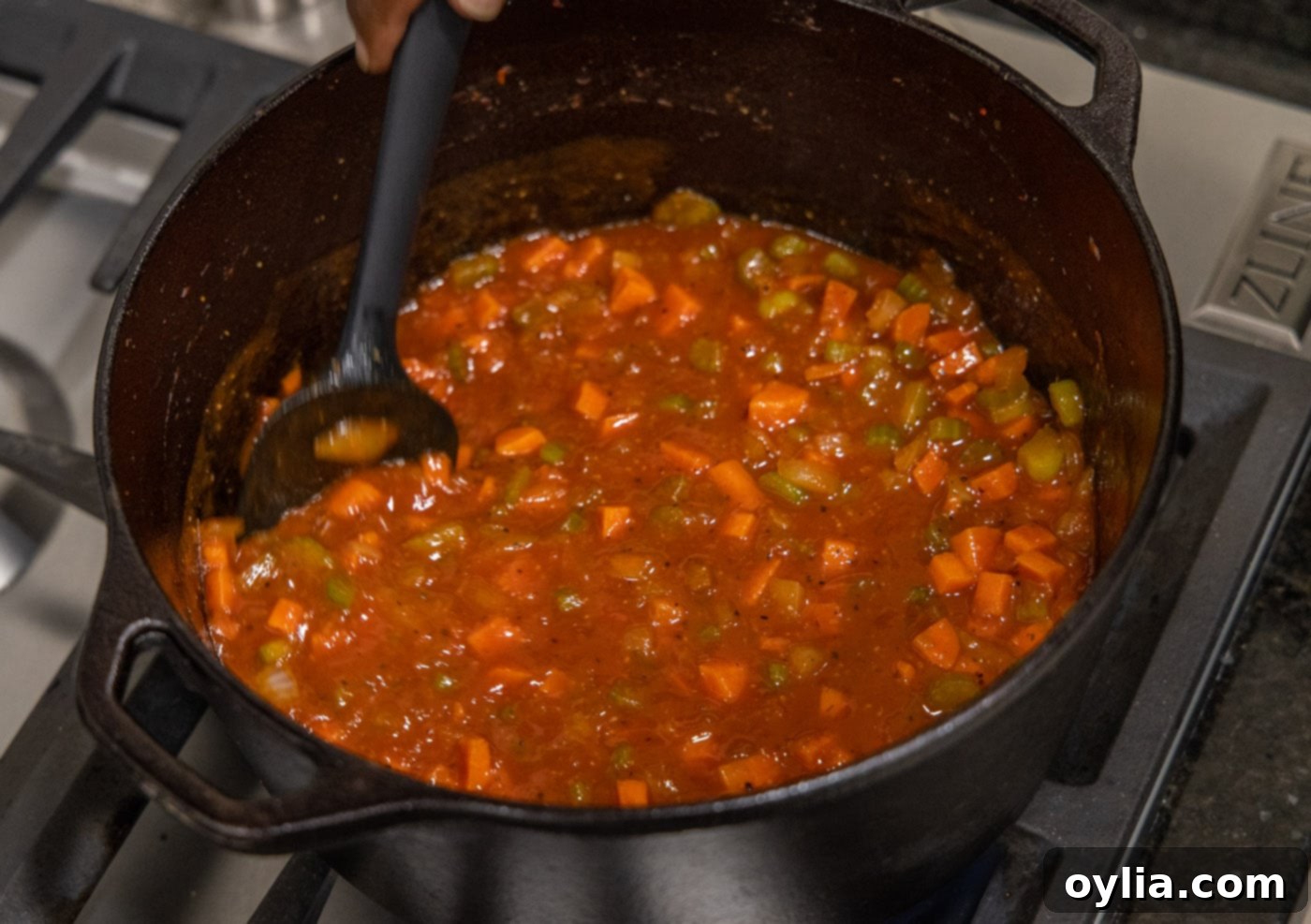 Stirring the flavorful braising liquid for veal osso buco