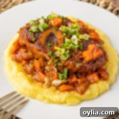 Veal Osso Bucco on polenta, garnished with fresh herbs