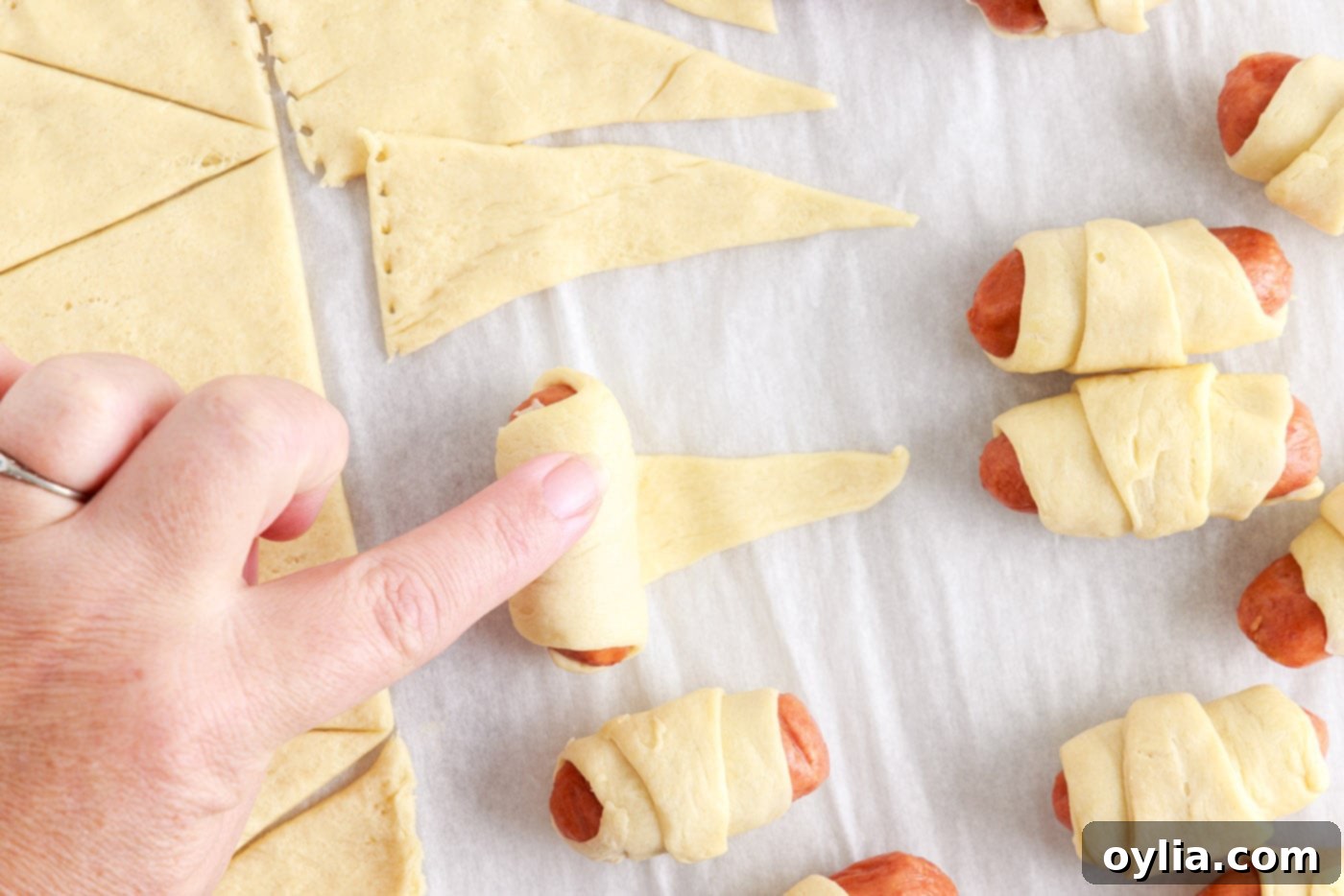another view of rolling mini dogs in crescent dough