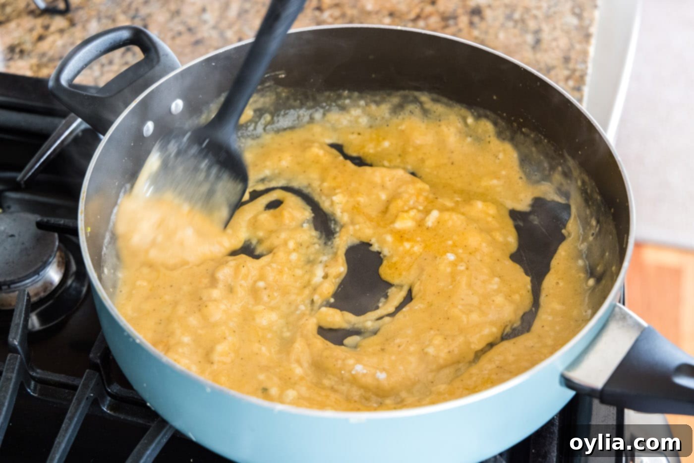 Continuously whisking the roux in the skillet until smooth