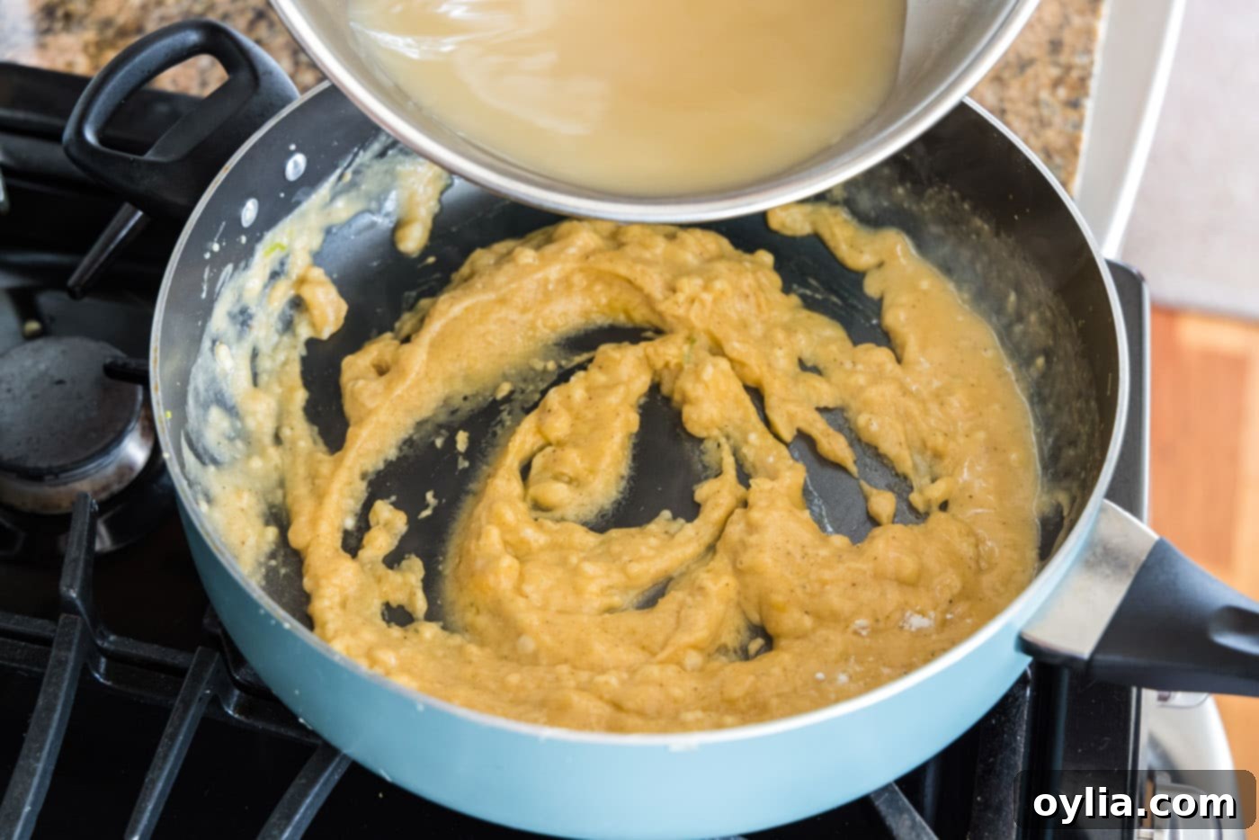 A close-up of a perfectly cooked roux with a paste-like consistency in a skillet