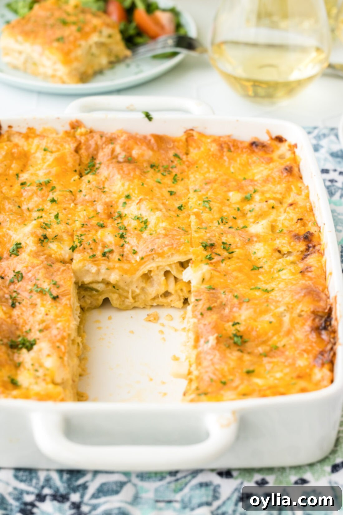 A baking pan filled with golden, bubbly seafood lasagna, fresh out of the oven