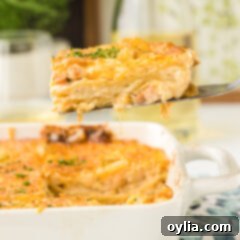 A slice of creamy seafood lasagna being lifted from the pan with a spatula