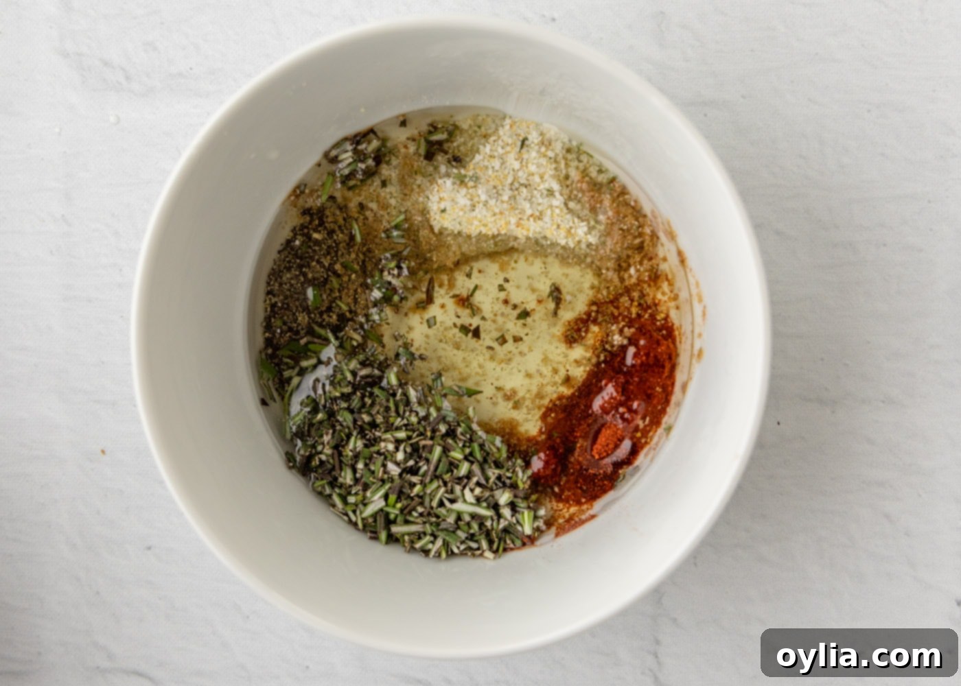 garlic salt, pepper, rosemary, paprika, liquid smoke, and olive oil in a medium bowl