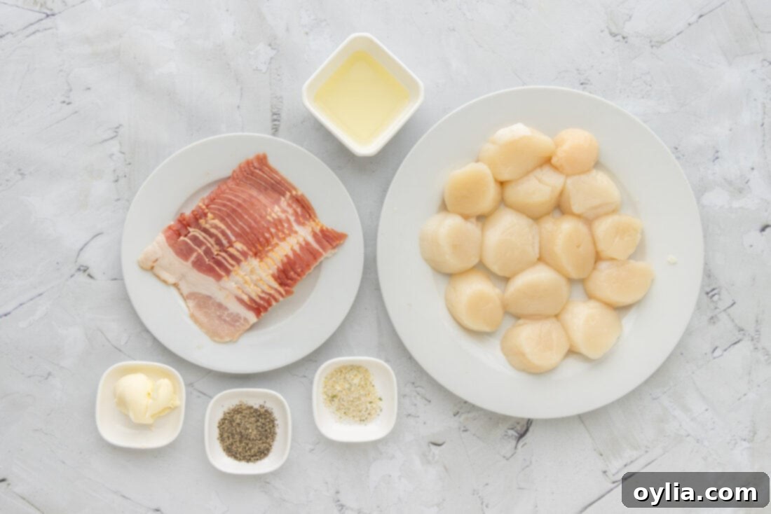 All the fresh ingredients laid out for making bacon wrapped scallops: raw scallops, bacon, olive oil, garlic salt, black pepper, and butter.