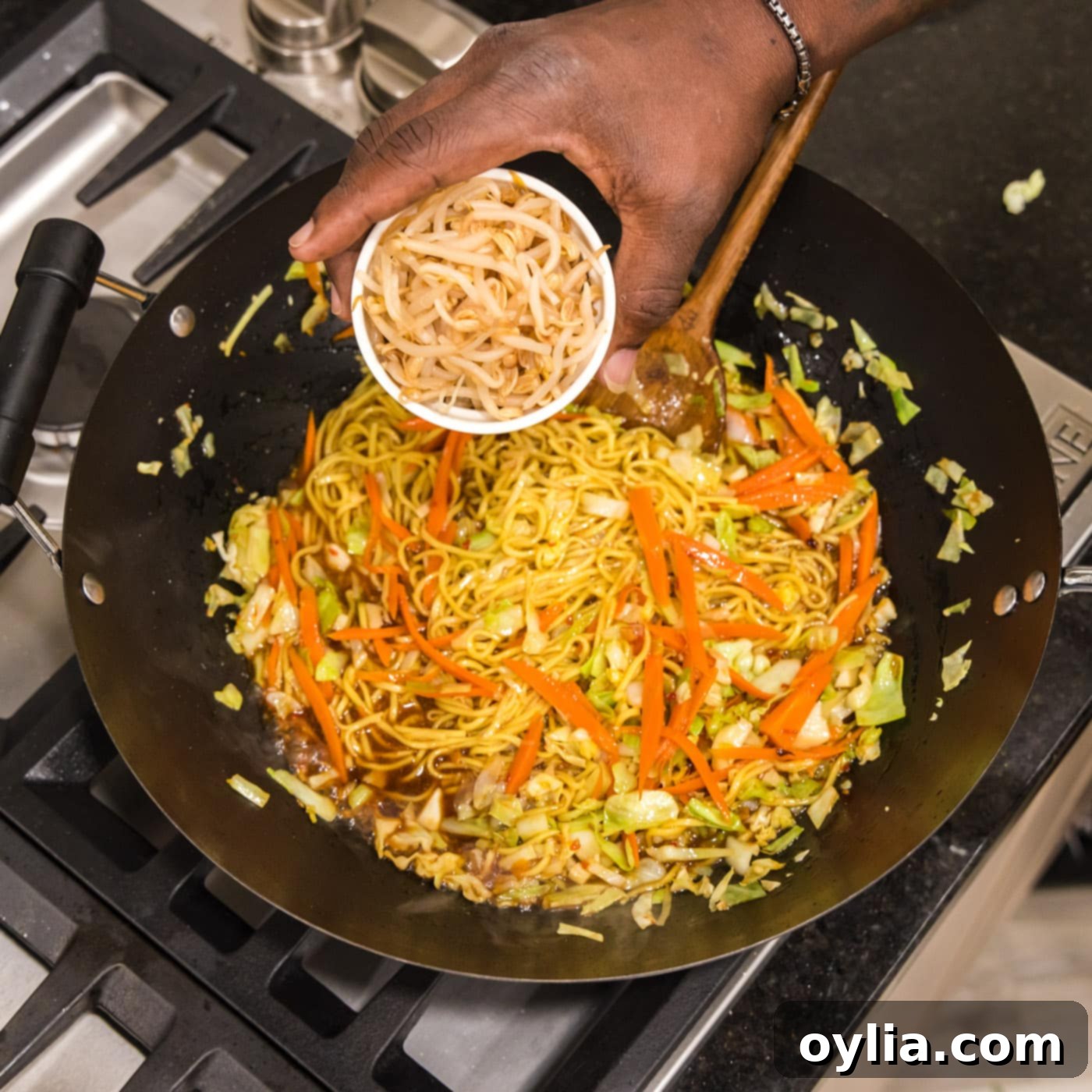 adding bean sprouts to chow mein