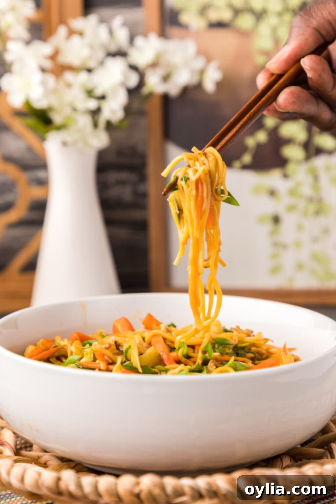lifting Chow Mein with chopsticks
