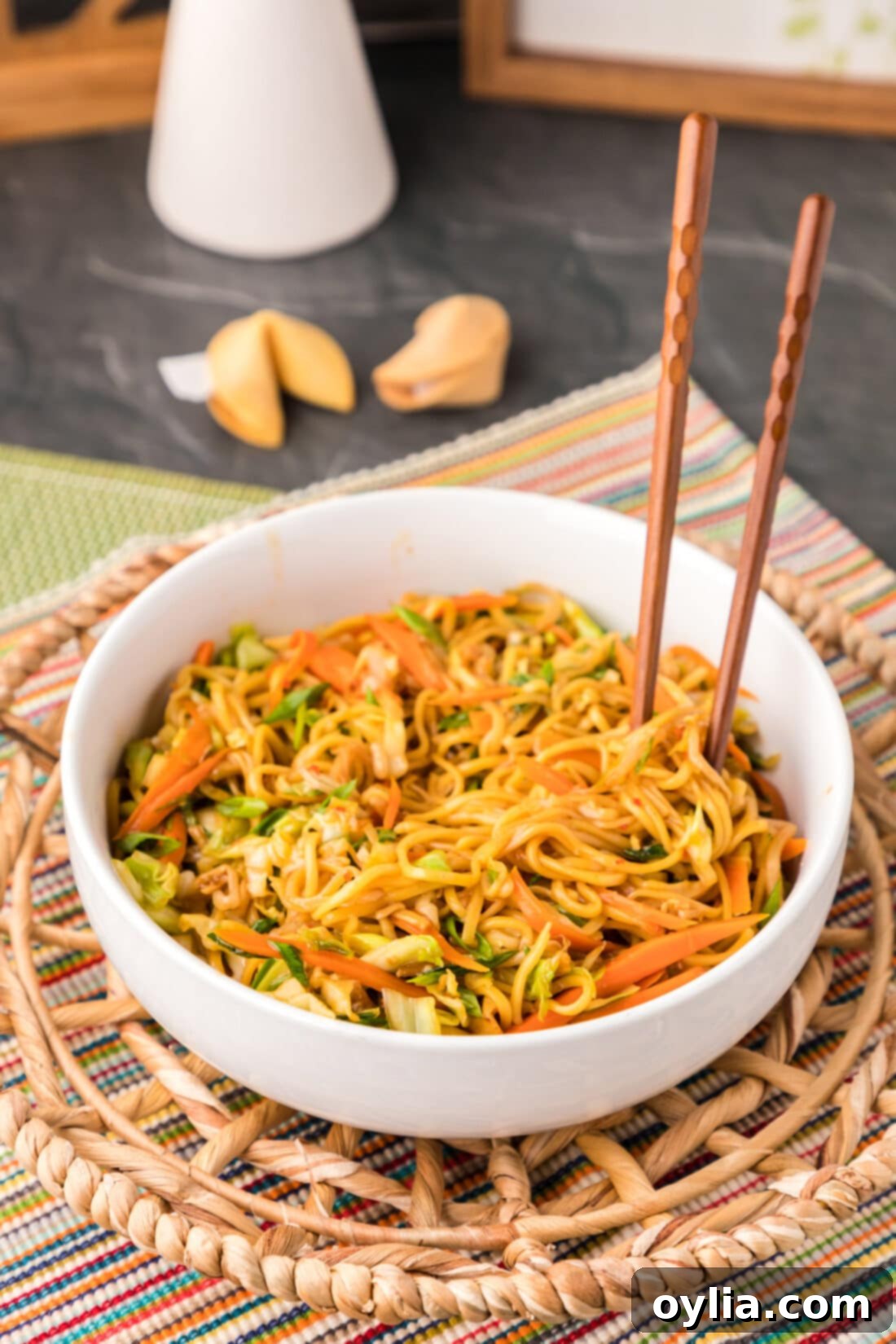 chopsticks standing in bowl of Chow Mein