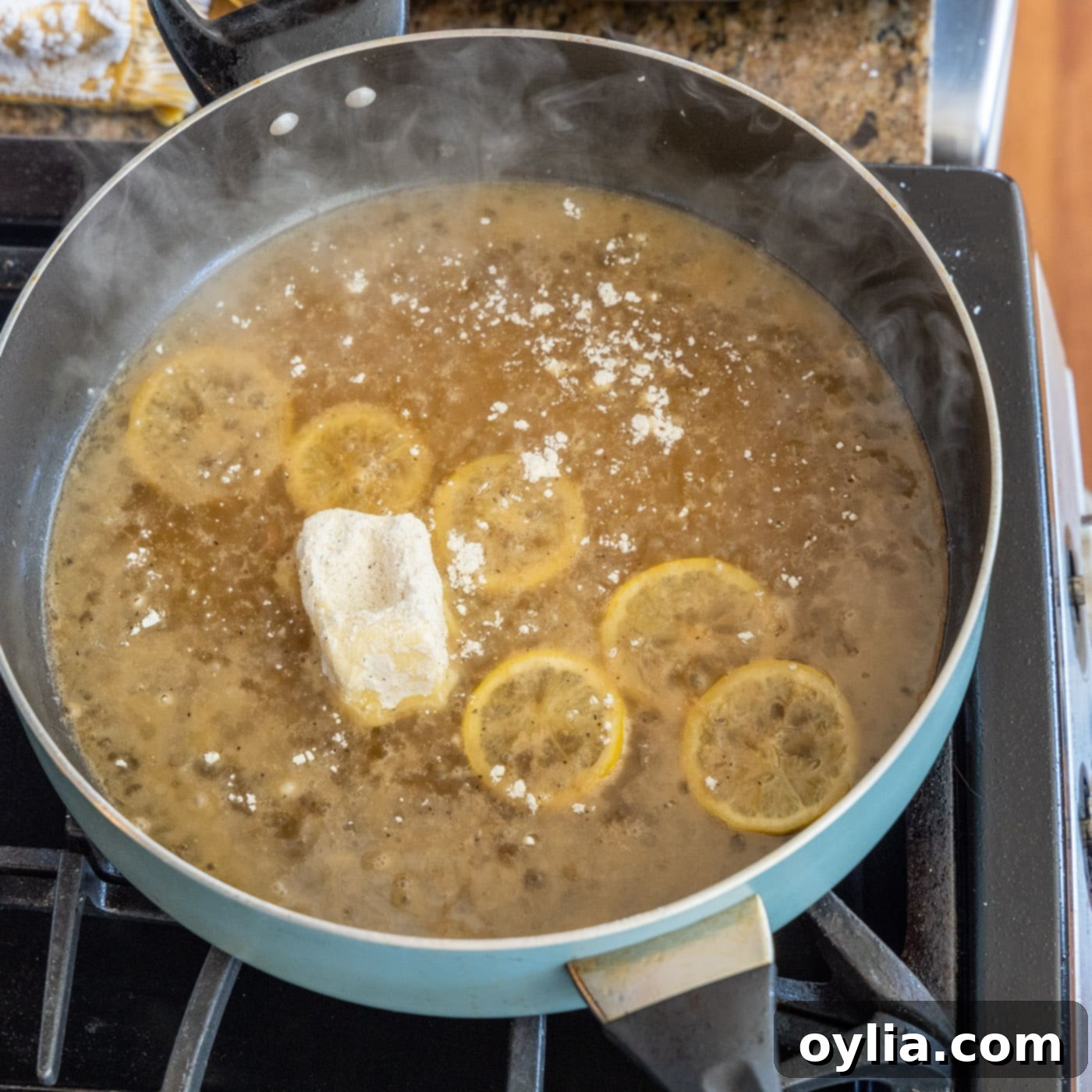 butter coated in flour added to skillet with lemon slices and white wine