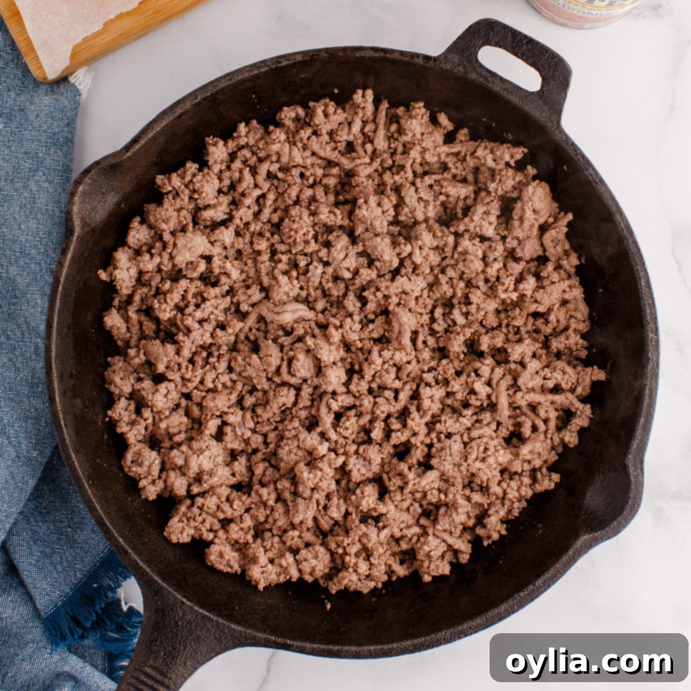 Browned and crumbled ground beef in a skillet after draining fat