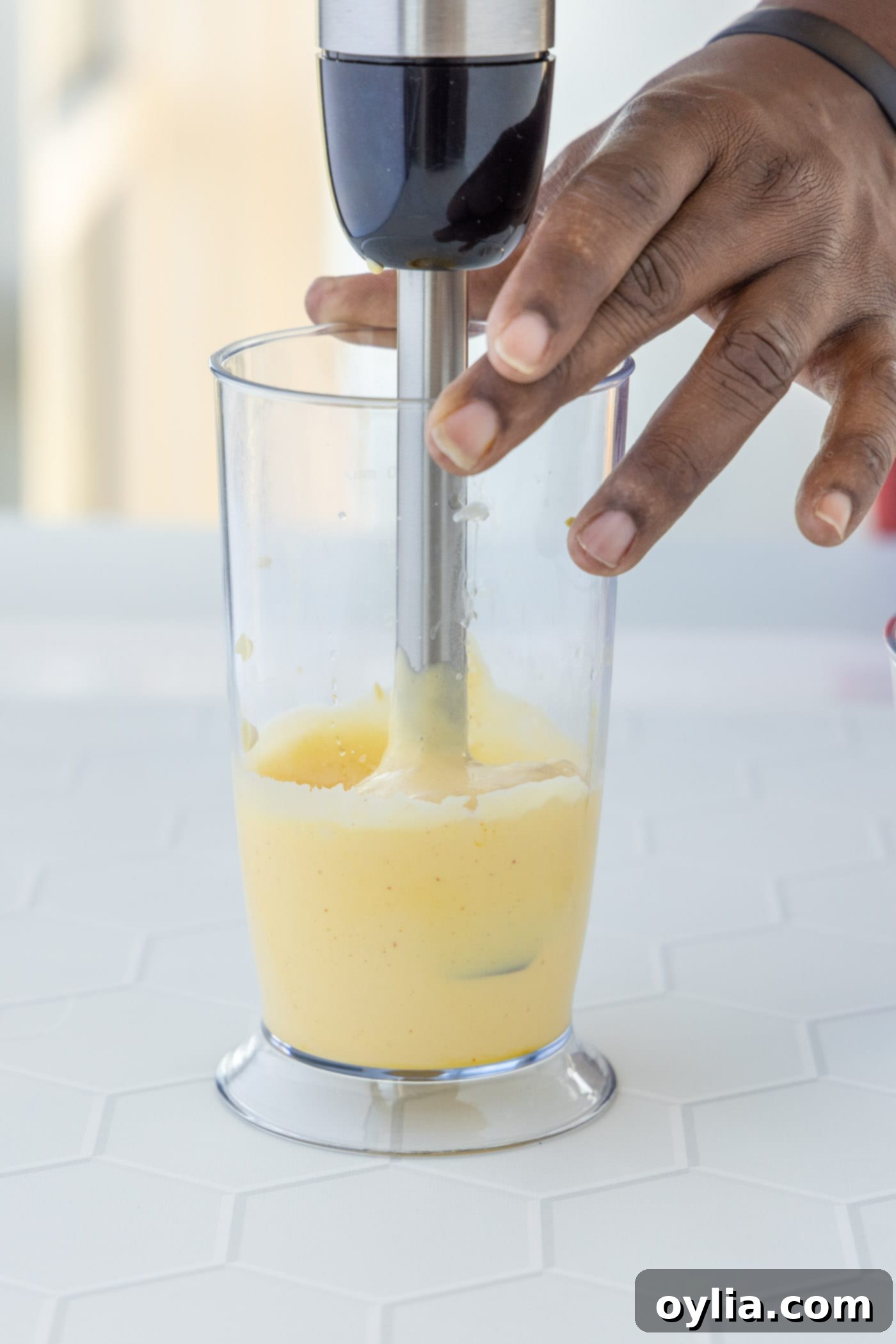blending hollandaise sauce with an immersion blender