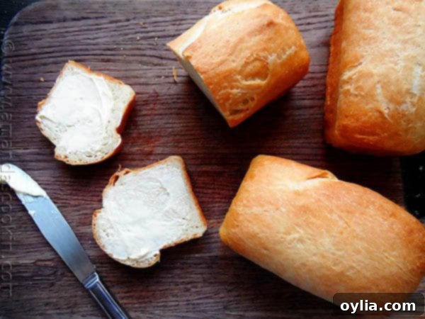 A photo of sliced Amish white bread mini loaves on a wooden cutting board, highlighting their soft texture.