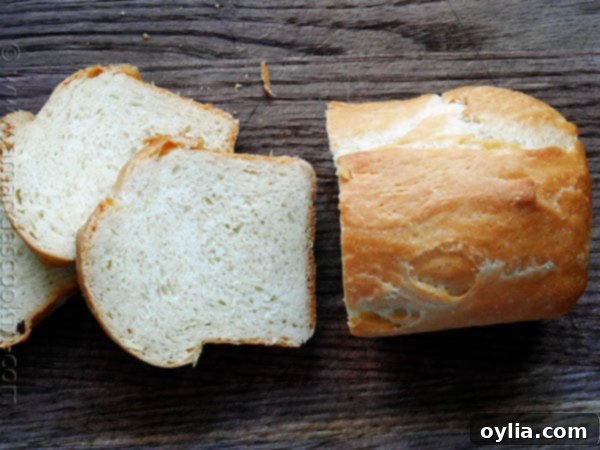 An overhead photo of a sliced Amish white bread mini loaf, revealing its soft and fluffy texture.
