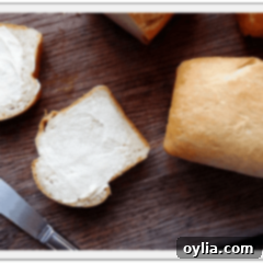 Soft Amish Mini White Bread Loaves 2 A close up photo of two buttered slices of Amish white bread, featured with the recipe card.