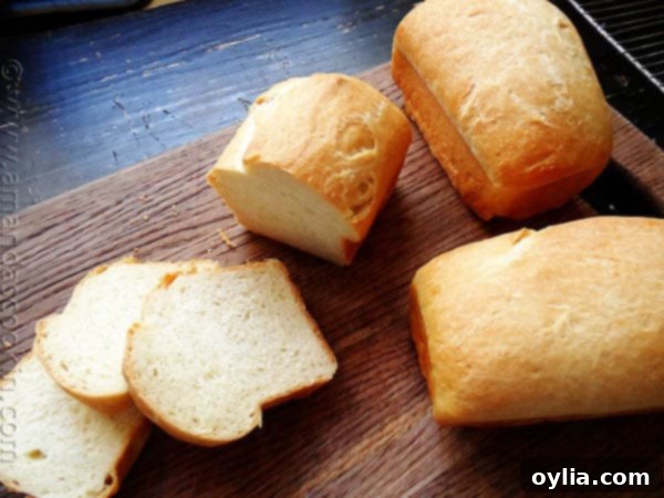A photo of a sliced Amish white bread mini loaf, ready to be enjoyed.
