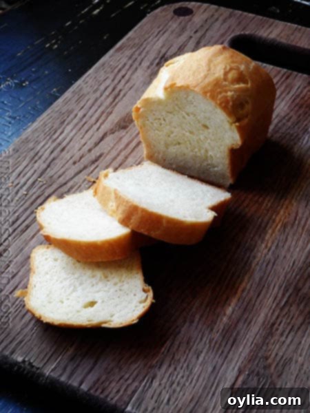 A photo of a single sliced Amish white bread mini loaf, perfect for individual servings.