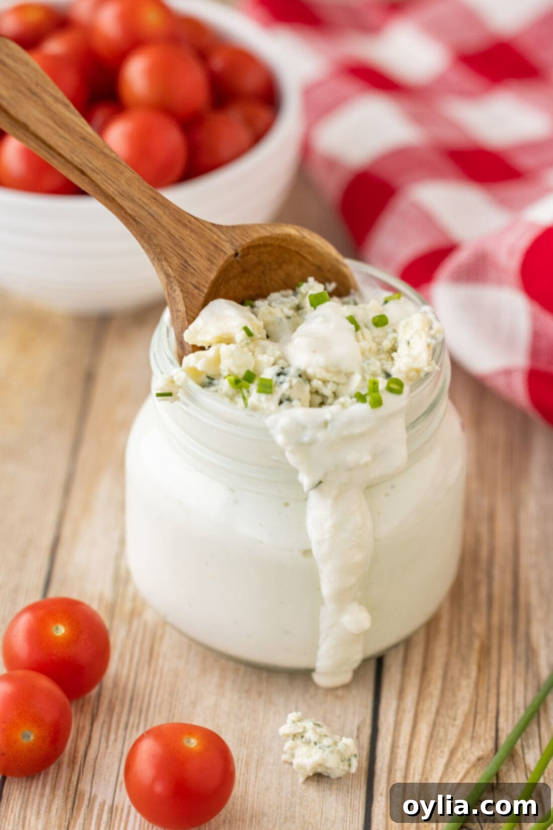Jar of Homemade Blue Cheese Dressing with a spoon, highlighting its creamy texture.