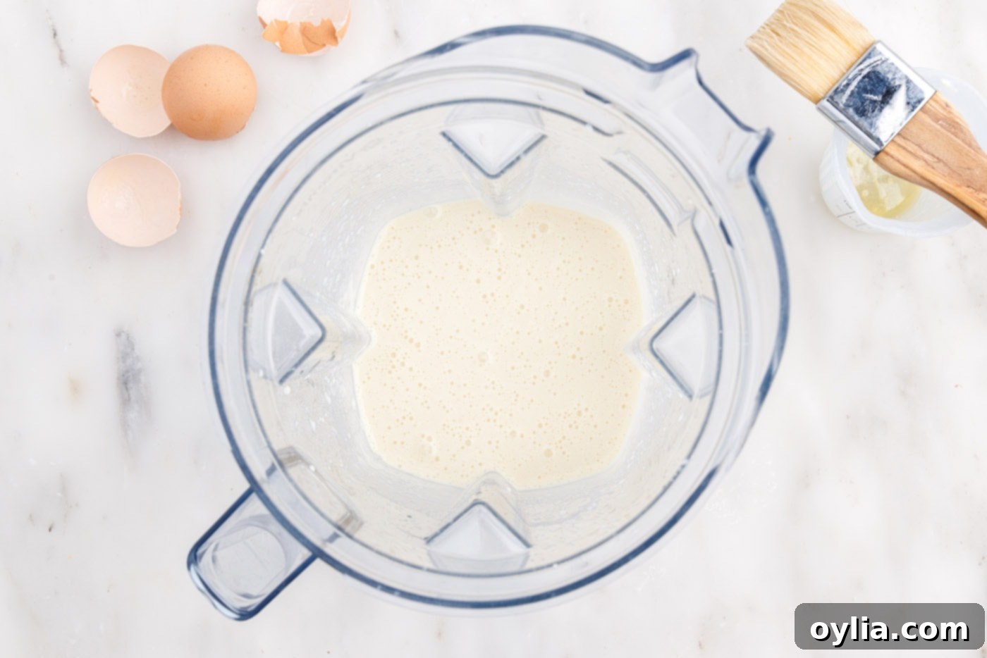 Smooth popover batter resting in a blender, ready for baking.