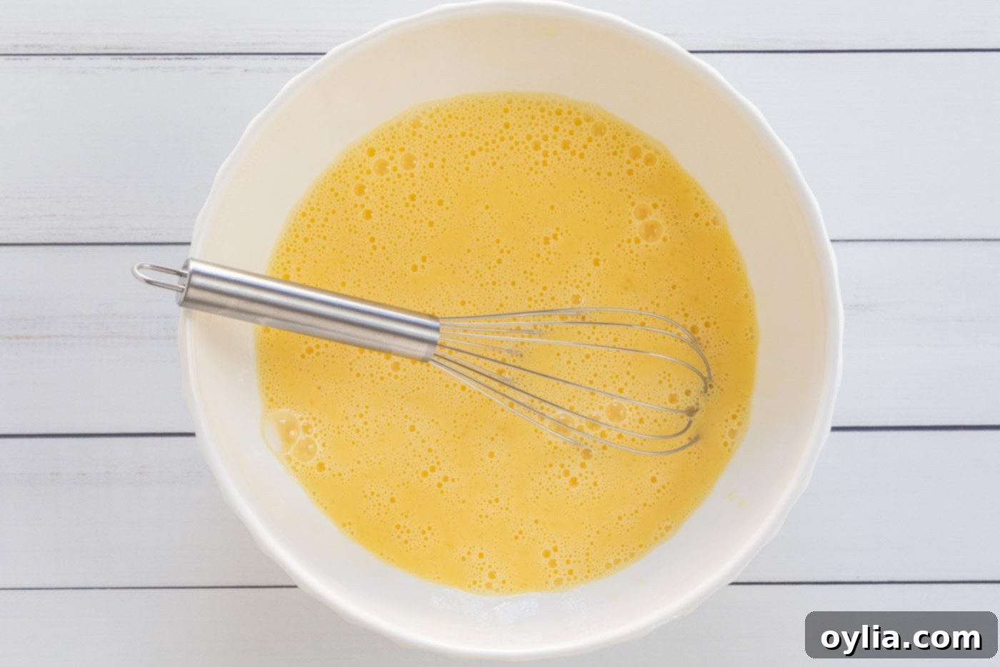 egg and milk mixture whisked in a bowl