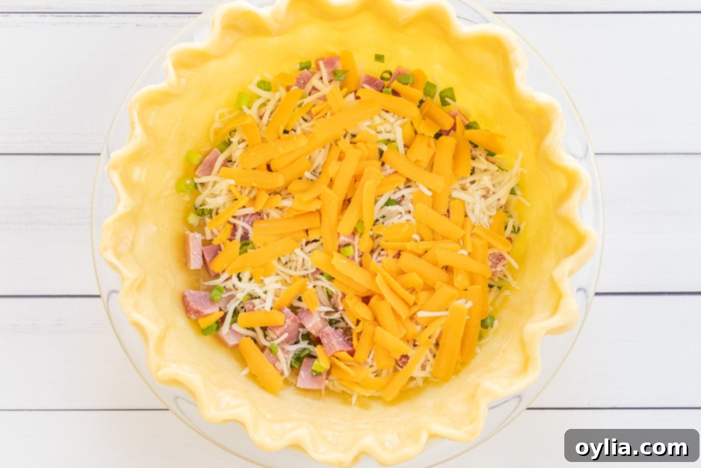cheddar cheese added on top of mozzarella and ham in quiche pie crust
