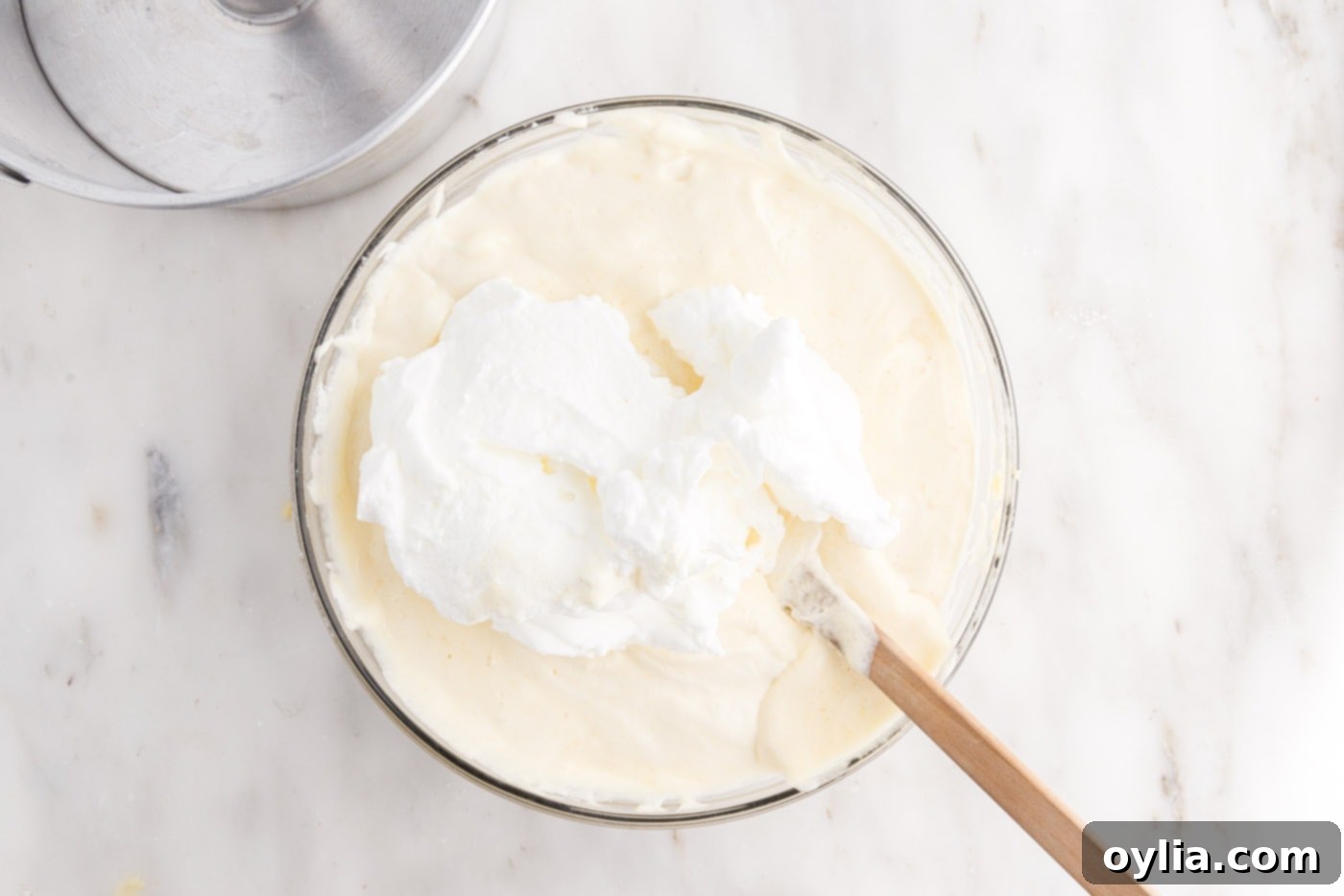 Final stage of folding egg whites into the chiffon cake batter with a rubber spatula