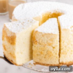 Chiffon Cake with slices being removed, showcasing its airy texture