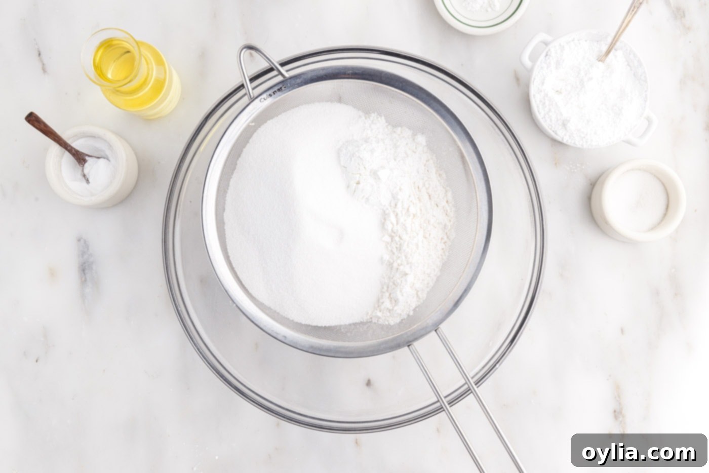 Sifting cake flour, sugar, baking powder, and salt into a bowl for chiffon cake